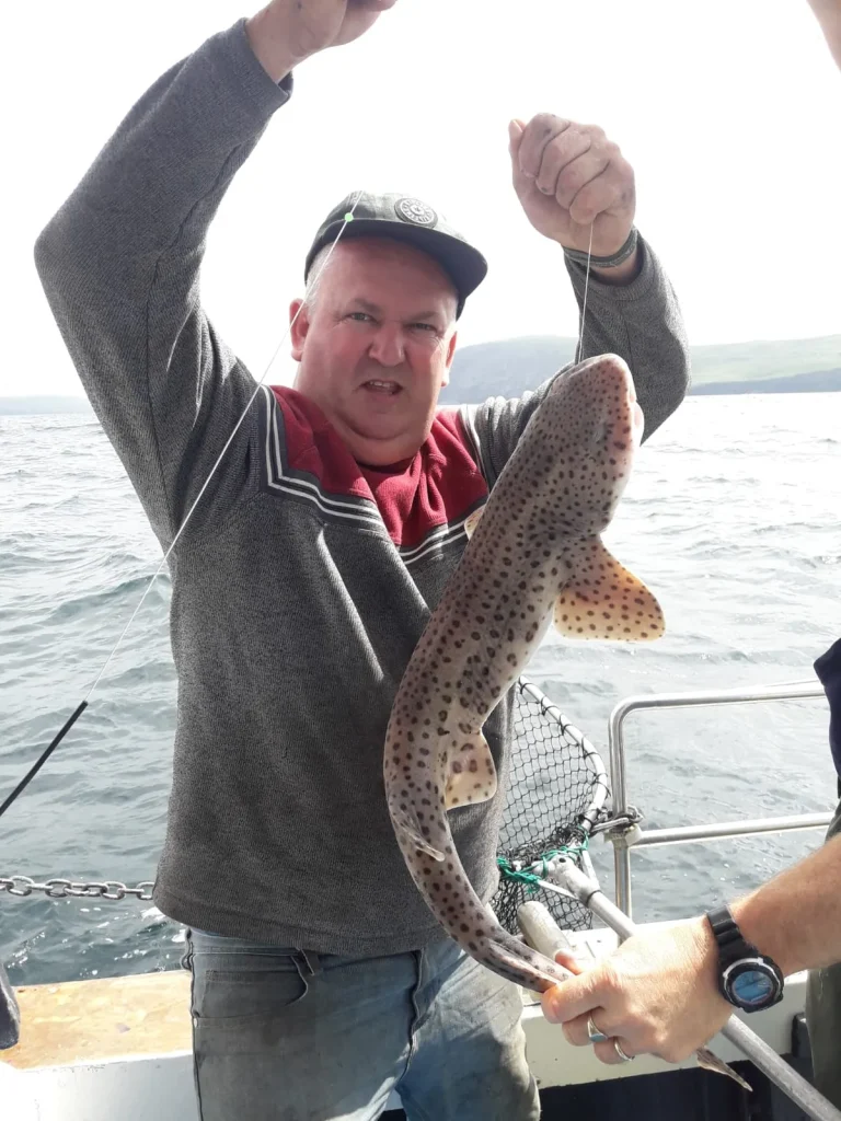 joel-mott-dQBkIZzyM-4-unsplash Angler holding a large spotted fish