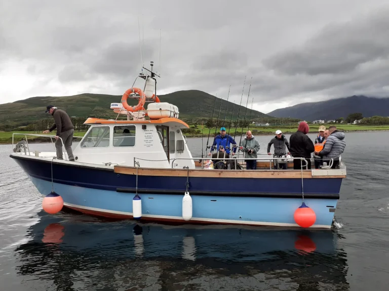 Home Saint Colette II fishing boat seen from the side with the crew on board