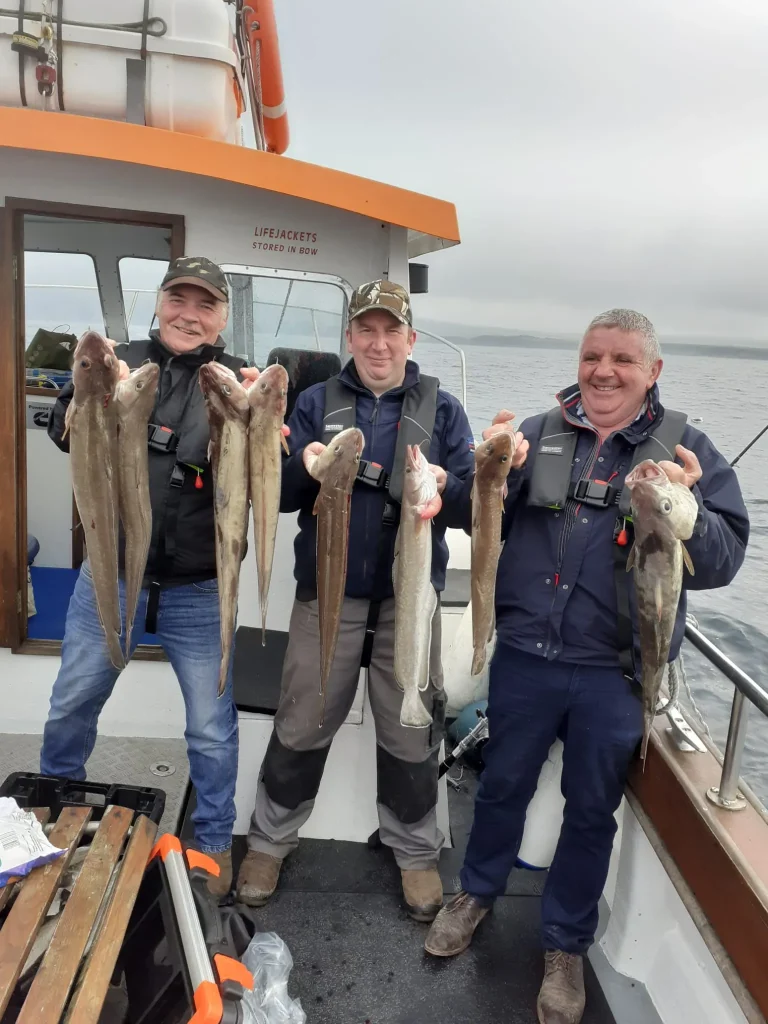 scott-goodwill-y8Ngwq34_Ak-unsplash Three anglers holding their catch